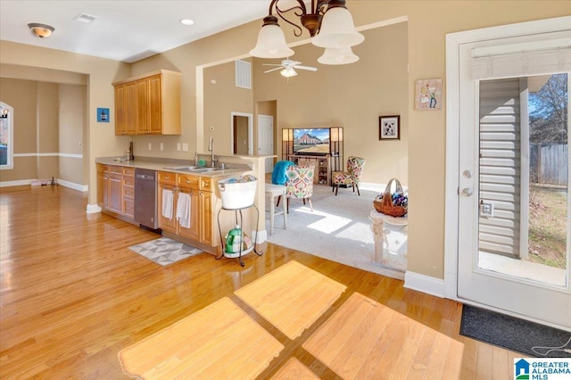 kitchen with light hardwood / wood-style floors, sink, pendant lighting, and ceiling fan