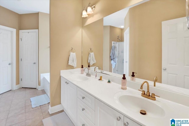 bathroom featuring a bath, tile patterned floors, and vanity