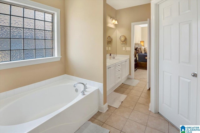 bathroom with vanity, a washtub, and tile patterned flooring