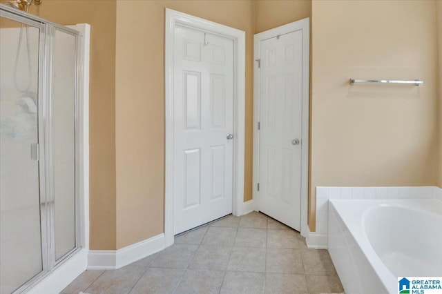 bathroom featuring tile patterned floors and shower with separate bathtub