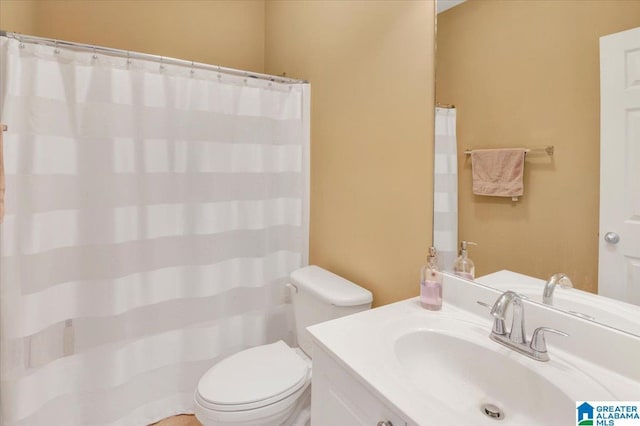 bathroom featuring toilet and vanity