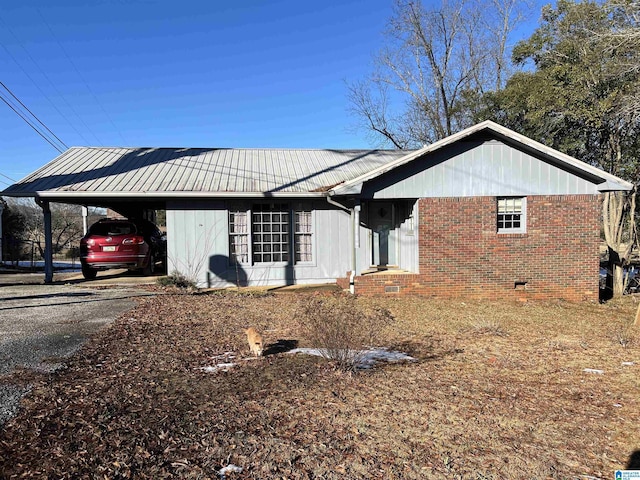 view of side of home with a carport