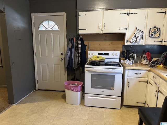 kitchen featuring electric stove and light tile patterned floors