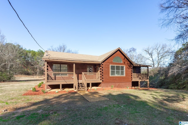 view of front of home with a front yard and a deck