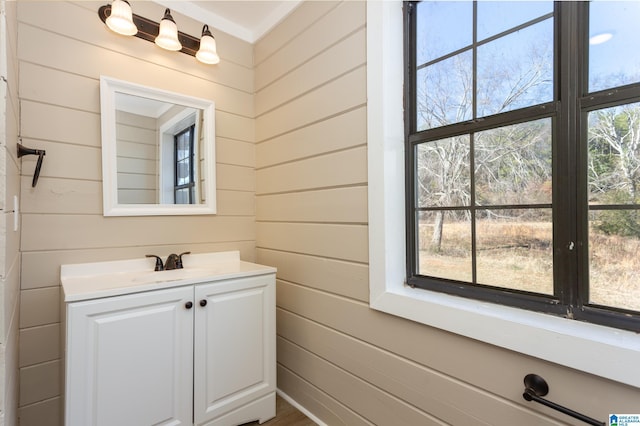 bathroom featuring vanity and wood walls