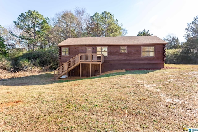 rear view of property featuring a yard