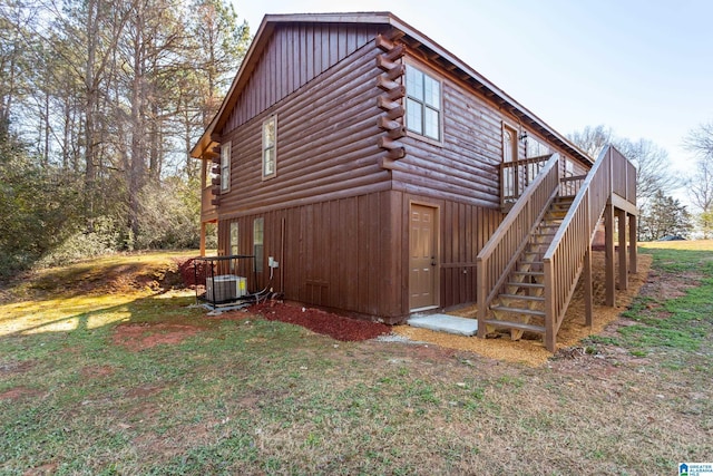 view of property exterior with a yard and a deck