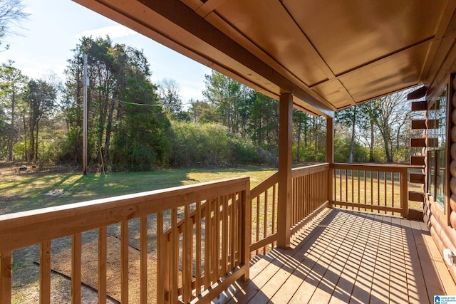 wooden terrace with a yard