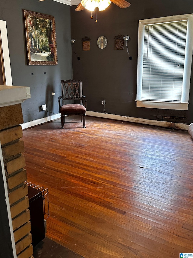 sitting room featuring ceiling fan, hardwood / wood-style floors, and crown molding