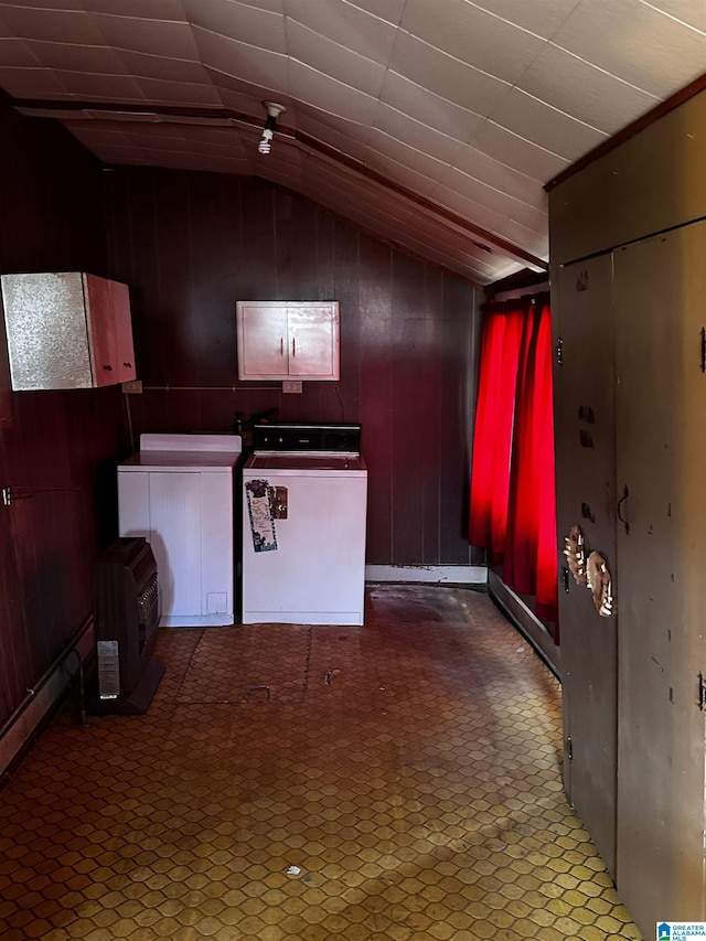 interior space with washer and clothes dryer, lofted ceiling, wood walls, and ceiling fan