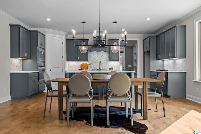 kitchen with pendant lighting, decorative backsplash, gray cabinets, and appliances with stainless steel finishes