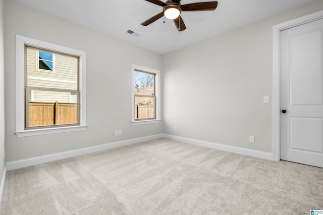 carpeted empty room featuring ceiling fan