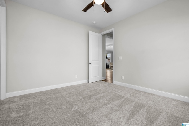 empty room with ceiling fan and carpet