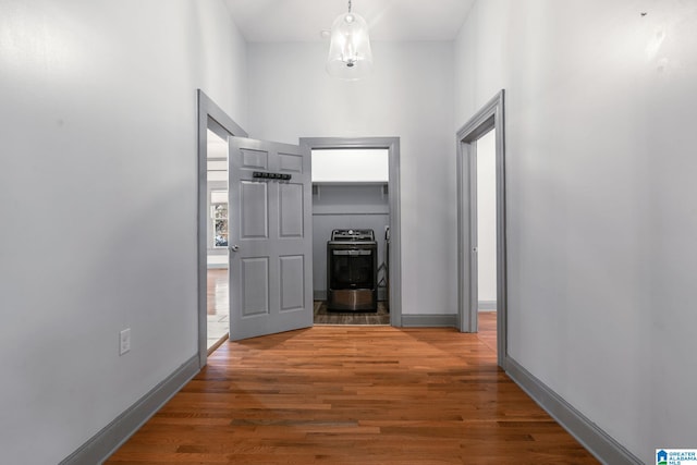 corridor with a towering ceiling and dark wood-type flooring