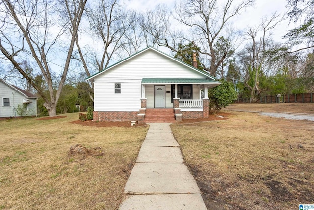 bungalow featuring a front lawn and covered porch