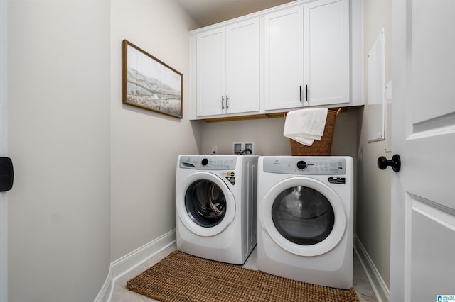 laundry area featuring cabinets, light tile patterned floors, and washing machine and dryer