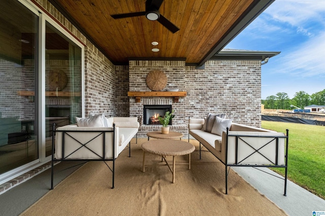 view of patio with an outdoor living space with a fireplace and ceiling fan