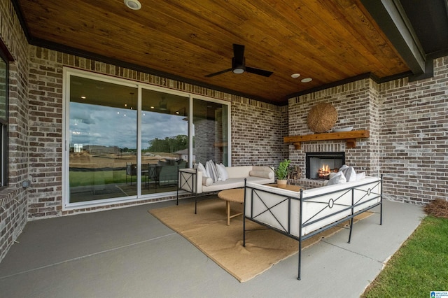 view of patio / terrace featuring an outdoor living space with a fireplace and ceiling fan