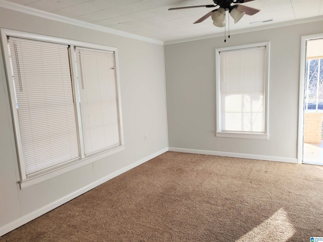 carpeted empty room featuring ceiling fan and ornamental molding