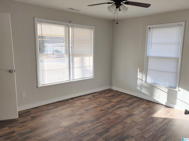 unfurnished room featuring ceiling fan and dark wood-type flooring