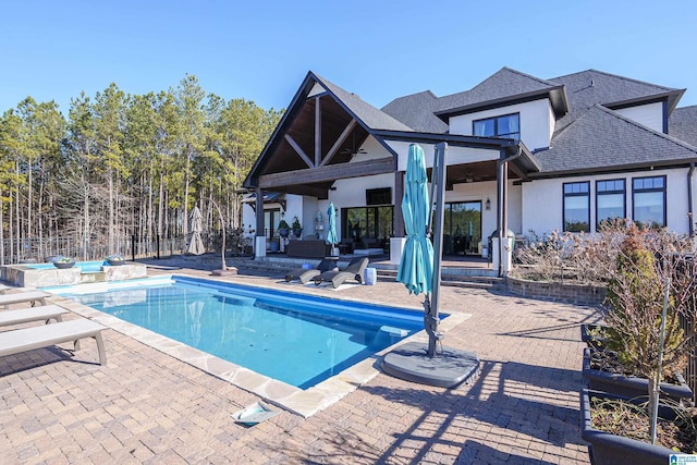 view of swimming pool featuring a patio area and a jacuzzi