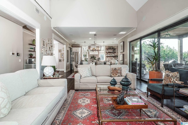 living room featuring ceiling fan, crown molding, hardwood / wood-style floors, and lofted ceiling