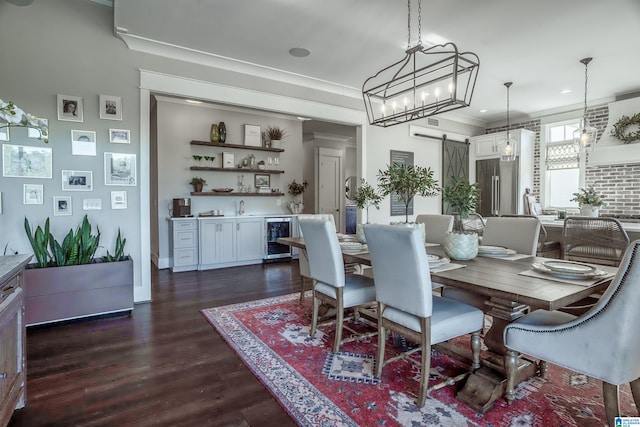 dining area featuring ornamental molding, a barn door, dark hardwood / wood-style flooring, and wine cooler