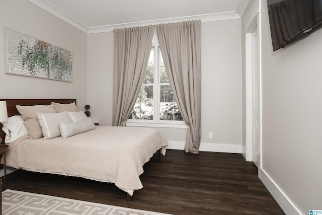 bedroom featuring crown molding and dark hardwood / wood-style floors