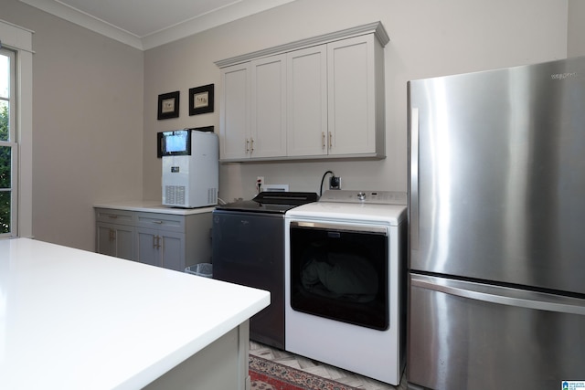 clothes washing area featuring separate washer and dryer and crown molding