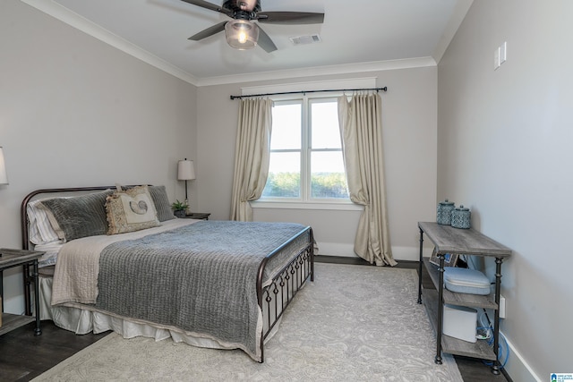 bedroom featuring ceiling fan, ornamental molding, and light hardwood / wood-style flooring