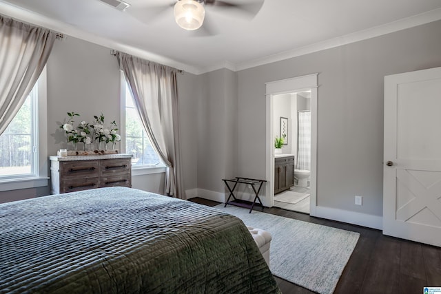 bedroom with dark wood-type flooring, ceiling fan, ornamental molding, and connected bathroom