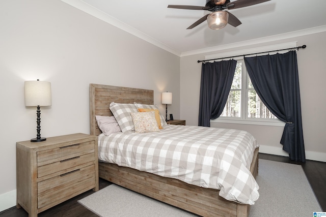 bedroom featuring dark wood-type flooring, ceiling fan, and ornamental molding