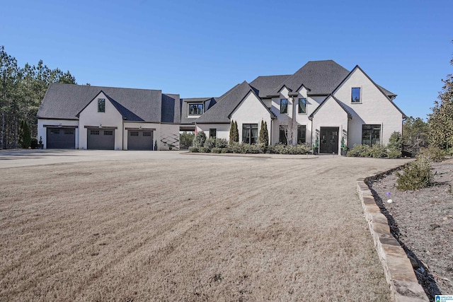 french country style house featuring a garage