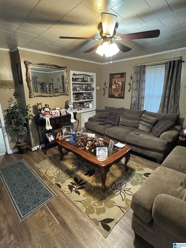 living room with wood-type flooring, ceiling fan, and ornamental molding