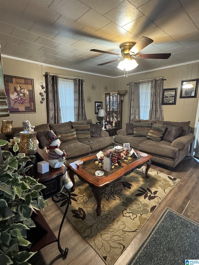 living room featuring hardwood / wood-style floors, a wealth of natural light, and ornamental molding