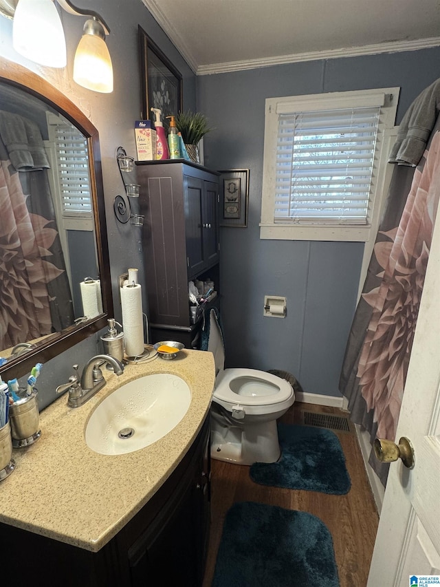 bathroom with vanity, toilet, ornamental molding, curtained shower, and wood-type flooring