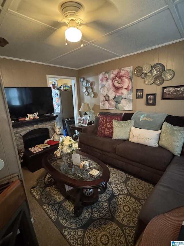 living room with ceiling fan, crown molding, and a fireplace