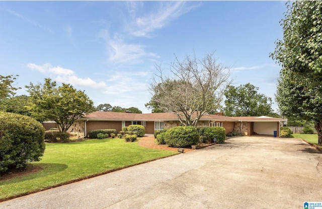 ranch-style home featuring a garage and a front yard