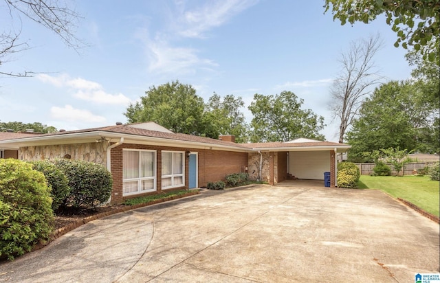 single story home with a front yard and a carport