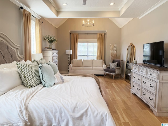 bedroom with vaulted ceiling, a notable chandelier, ornamental molding, and light hardwood / wood-style floors