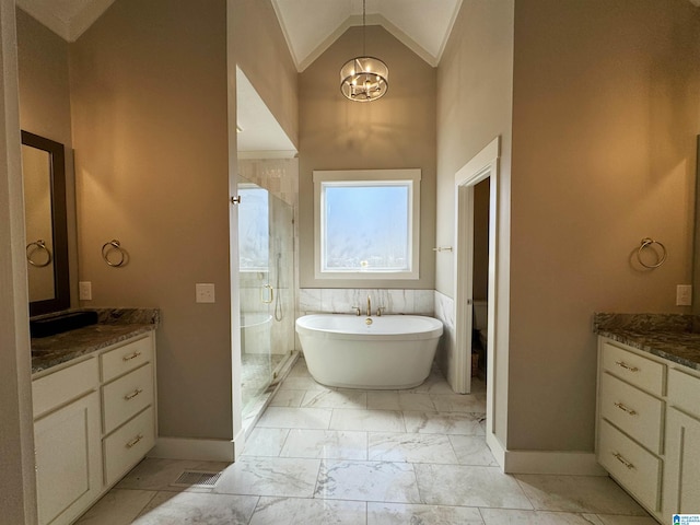 bathroom with vanity, vaulted ceiling, ornamental molding, and shower with separate bathtub