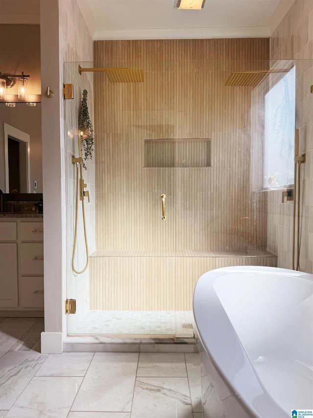 bathroom featuring a shower with shower door, vanity, and ornamental molding