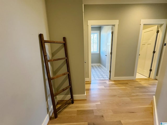 corridor with light hardwood / wood-style floors