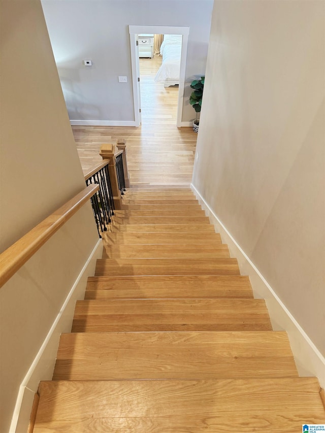 stairs with hardwood / wood-style floors