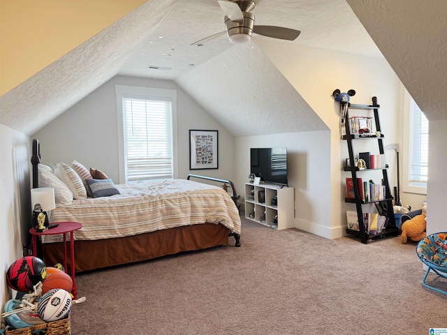 bedroom featuring ceiling fan, a textured ceiling, carpet floors, and lofted ceiling