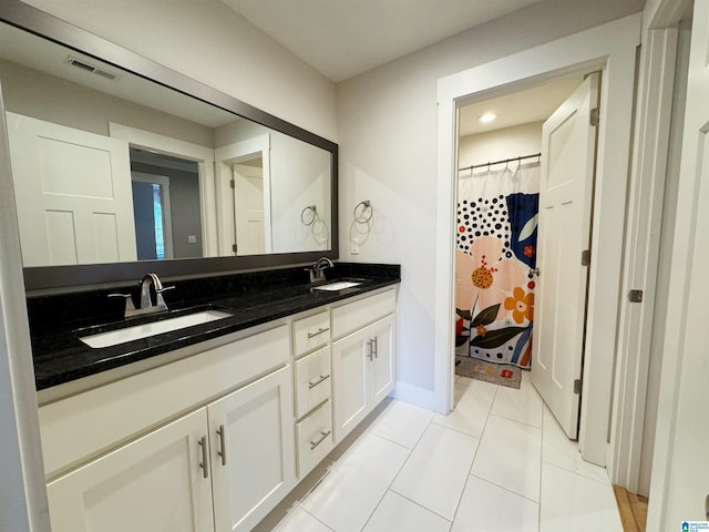 bathroom with vanity and tile patterned flooring