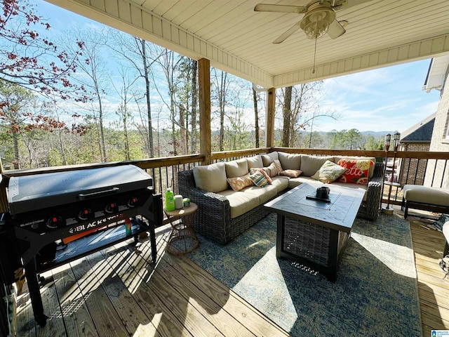 deck featuring ceiling fan, outdoor lounge area, and a grill