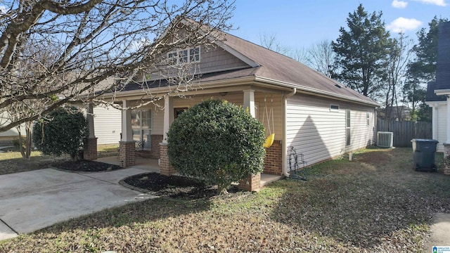 view of side of property with a patio area, a yard, and central AC unit