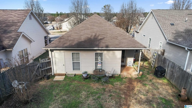 rear view of property featuring a yard