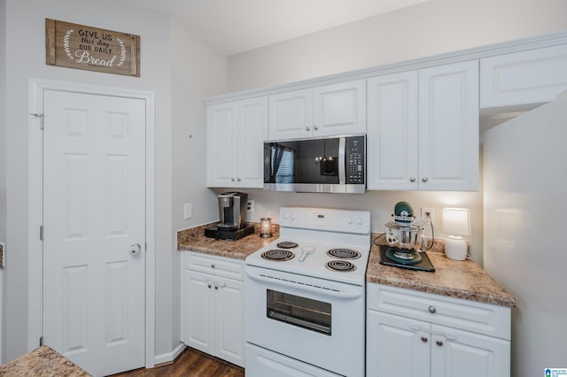 kitchen featuring white cabinets, dark hardwood / wood-style floors, and white appliances